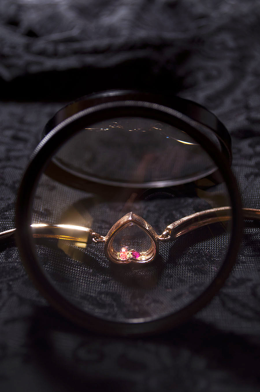 Rebecca_Huang_still_life_photography_dark_velvet_accessories_bracelet_jewelry_lens_magnifying_reflection_heart_gold_jewels_floral