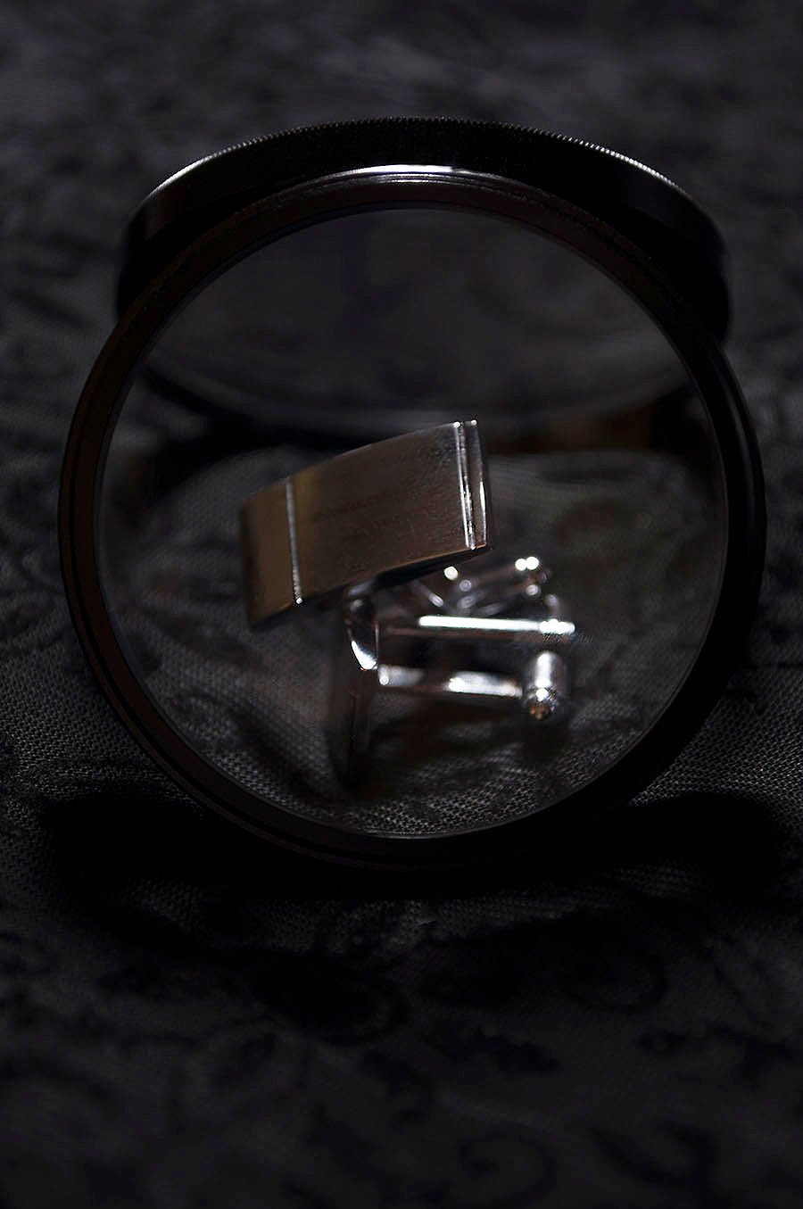 Rebecca_Huang_student_photography_still_life_accessories_cuff_links_silver_minimal_lens_magnifying_black_velvet_floral_dark