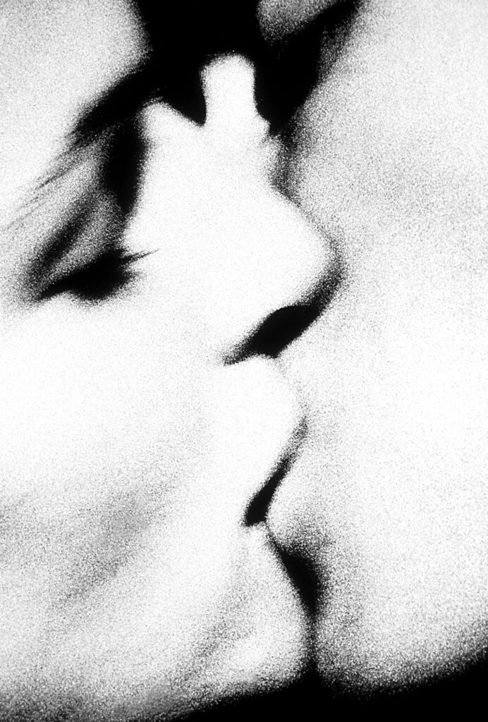 a portrait of two young lovers kissing