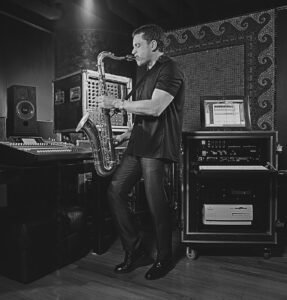 Saxophone player in studio recording music