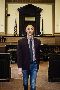 Man is suit and tie leaving courtroom