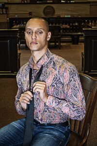 Man taking off his time in courtroom jury box