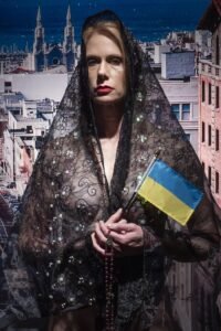 We Stand With Ukraine. Mother in mourning holding Ukranian Flag