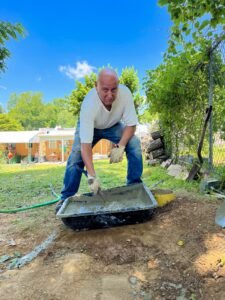 Portrait of Anthony Colagreco mixing cement