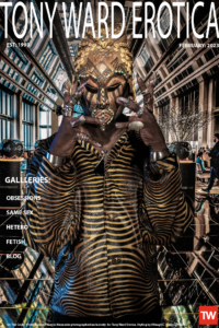 Homepage photo of man wearing African mask and KVaughn leopard shirt for Tony Ward Erotica homepage February 2023