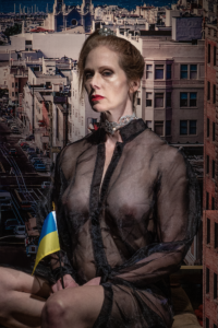 Portrait of middle aged woman holding Ukranian flag wearing black sheer dress