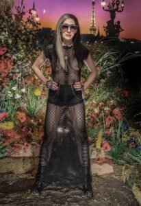 Portrait of hair stylist Tracey Olkus wearing black sheer dress on night out in Paris