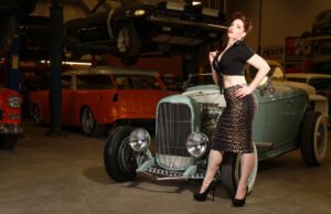 Portrait of Kitchie Ohh in front of an antique car