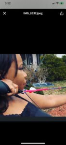 Nefertari Williams shooting with a archery bow and arrow