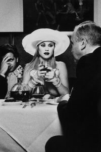 Tony Ward photography from the book of Tableaux Vivants woman seated at fancy restaurant topless with two men